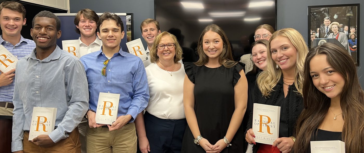 MCPP staff and Leadership Academy participants holding The Rational Optimist